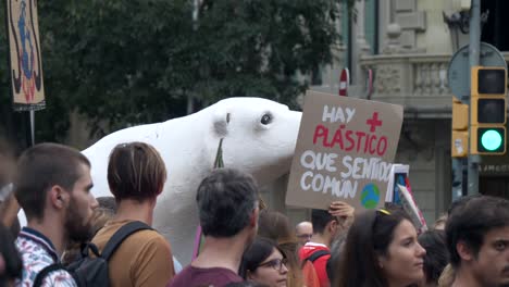 Climate-change-activism-crowd-gathered-holding-fake-polar-bear-environmental-demonstration