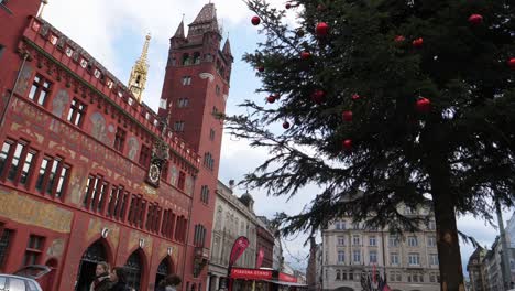 Medium-shot,-Christmas-Tree-with-red-ball-ornament,-Basel-town-hall-in-the-background
