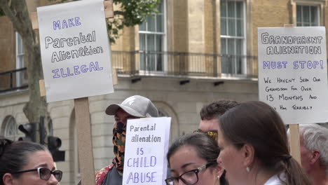 People-on-a-protest-for-non-resident-parent-rights-outside-Downing-Street-hold-placards-that-say,-“Make-Parental-Alienation-Illegal”-and-“Grandparent-Alienation-Must-Stop