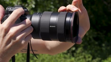 Close-up-shot-of-neutral-density-filter-being-turned-on-camera-lens