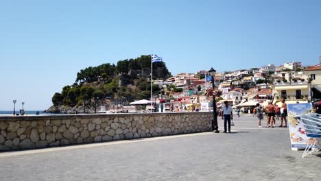 People-walking-during-the-morning-hours-in-Parga,-Greece-on-a-sunny-day-Timelapse