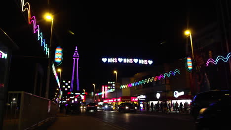 LOVE-NHS-illuminated-sign-sits-across-busy-street-with-Lit-Up-Blackpool-Tower-in-the-Background-2020-Virtual-Switch-On