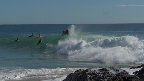 Surfista-Profesional-Montando-Olas-En-Rocas-De-Pargo---Actividad-De-Playa-Durante-El-Verano-En-Coolangatta,-Australia---Tiro-De-Seguimiento