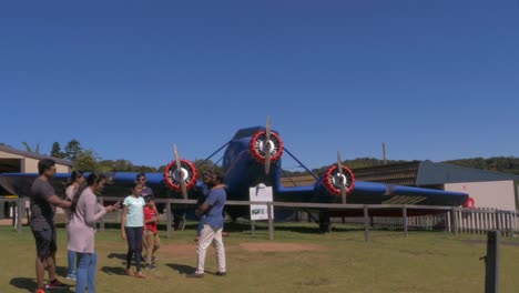 Tourists-Taking-Pictures-At-The-Stinson-Plane-Replica---O'Reilly's-Rainforest-Retreat-At-Lamington-National-Park---Canungra,-Gold-Coast,-QLD,-Australia