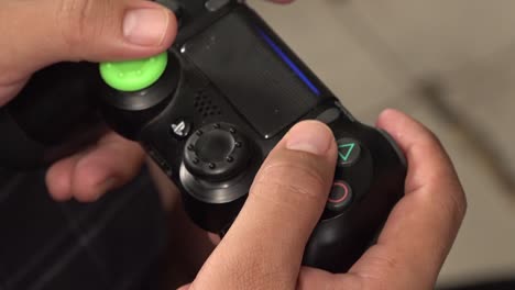 A-player-pressing-buttons-on-a-videogame-controller