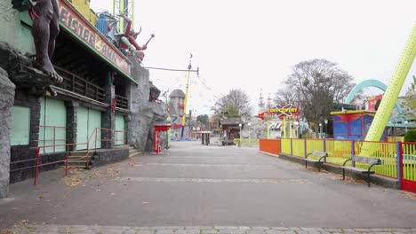 empty-street-in-usually-crowded-area-in-fun-park-next-to-a-fake-haunted-house-during-lockdown-slow-motion