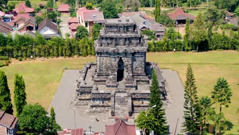 Facade-of-ancient-Mandut-temple-in-Buddhist-monastery-on-Java,-Indonesia,-aerial