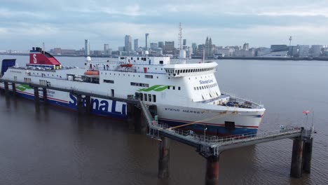Stena-Line-freight-ship-vessel-loading-cargo-shipment-from-Wirral-terminal-Liverpool-aerial-view-zooming-out-shot