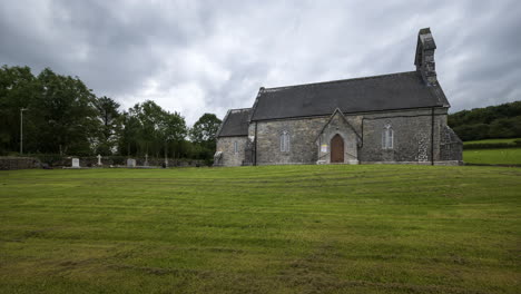 Time-lapse-of-a-historical-church-in-rural-landscape-with-grass-cut-in-Ireland-during-a-cloudy-day