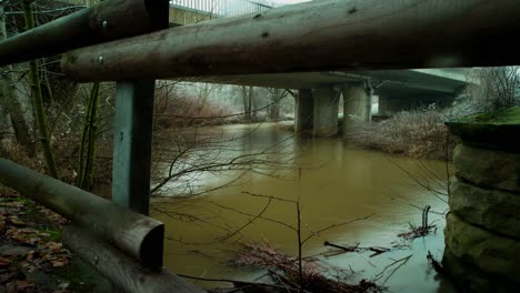 A-time-lapse-on-a-winter-day-under-a-bridge-of-a-river