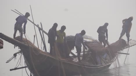 Bangladeshi-fishermen-pulling-nets-from-the-river-water