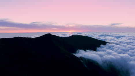 Drone-hyperlapse-above-clouds-at-sunset---curious-cloud-movement-around-mountain