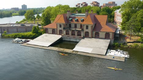 People-in-Kayaks-Paddle-Past-the-Weld-Boat-House-on-Harvard's-Campus