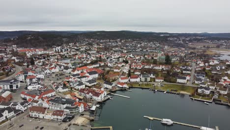 High-altitude-aerial-over-Lillesand-town-in-southern-Norway---Slowly-flying-backwards-while-revealing-full-town-and-marina