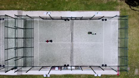 Bird's-eye-view-of-two-athletes-playing-paddle-in-outdoors-court
