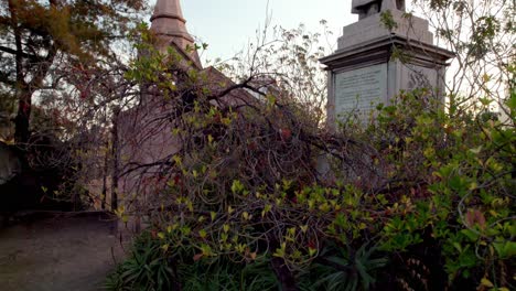 Jib-down-on-Benjamin-Vicuña-Mackenna-Tomb-in-hermitage-place-at-Santa-Lucia-Hill-surrounded-by-vegetation-at-sunset,-Santiago,-Chile