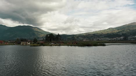 Sailing-Through-Calm-Waters-Of-San-Pablo-Lagoon-Near-Otavalo,-Ecuador