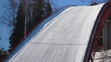Close-up-shot-of-ski-jumper-jumping-on-the-snowy-track