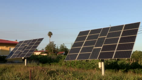 Two-large-solar-panels,-on-farmland-next-to-the-dwellings