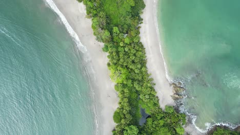 Aerial-top-away-shot-of-Whale-tail-shaped-beach-in-Manuel-Antonio-National-Park,-Costa-Rica