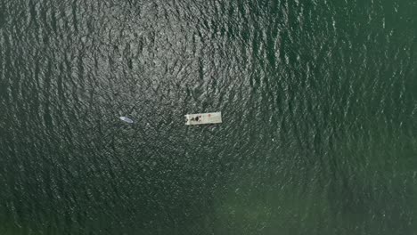 Overhead-Shot-Of-Fishing-Boat-Anchored-Middle-Of-Blue-Calm-Ocean