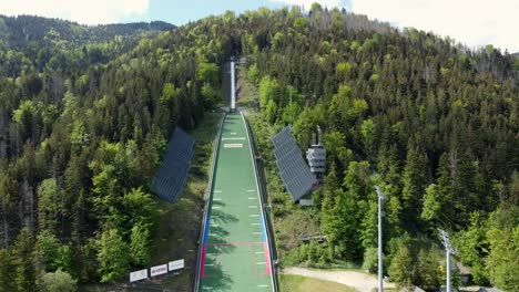 Close-Up-of-The-Great-Krokiew-"Wielka-Krokiew"-Ski-Jumping-Hill-stadium-in-the-Tatra-Mountains-near-Zakopane,-a-resort-town-with-traditional-Goral-architecture-in-Southern-Poland---4K-Smooth-Backward