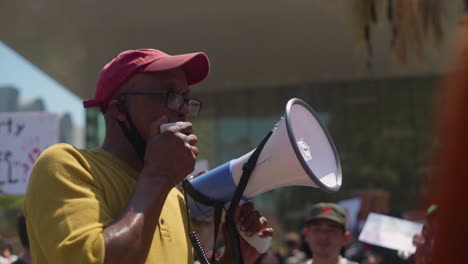 A-Black-Man-with-a-megaphone-leads-a-group-of-protesters-at-a-BLM-protest-outside-City-Hall
