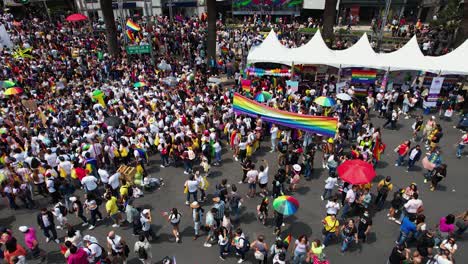 Aerial-view-above-crowded-streets,-during-the-Gay-Pride-Parade---circling,-drone-shot