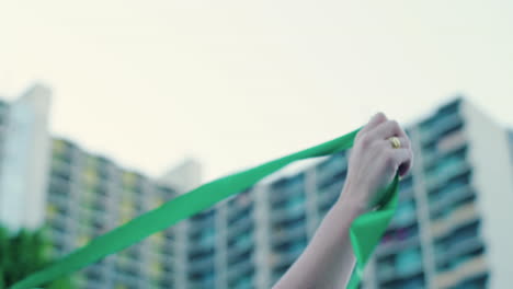 A-Woman-waves-green-ribbon-while-marching-in-a-pro-choice-abortion-rights-rally-in-the-streets-of-Downtown