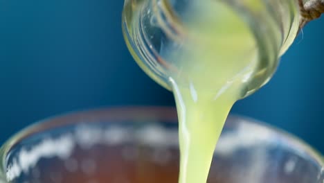 Close-up-of-glass-bottle-pouring-out-fresh-juice