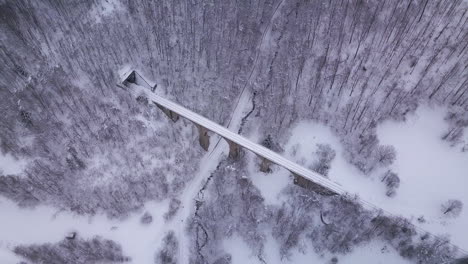 Stunnig-aerial-shot-showing-an-old-train-viaduct-with-a-tunnel-entering-through-the-mountain-at-the-end-of-it