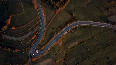 Aerial-footage-showing-two-cars-passing-by-each-other-in-a-U-turn