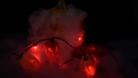 pepper-jack-o-lanterns-and-a-pumpkin-with-dry-ice-fog-coming-out-dark-photography