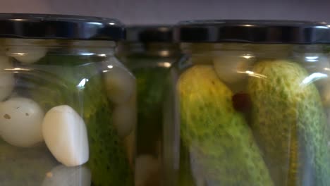 Sliding-shot-of-pickled-cucumbers-in-glasses