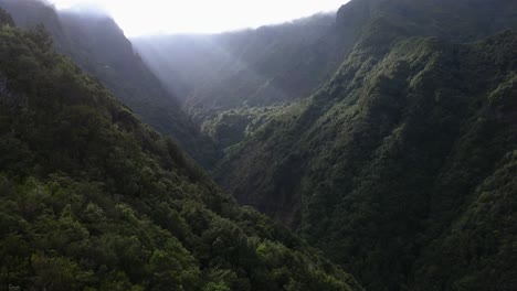 Madeira,-Portugal---Stunning-Scenery-Of-Lush-Mountain-Range-Lightened-By-Beam-Of-Sunlight---Aerial-Drone-Shot