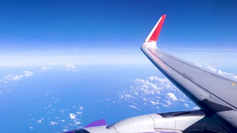 Helle-Und-Schöne-Blaue-Himmellandschaft,-Höher-Schwebende-Bewegungswolke,-Flugzeugfenster-Und-Motor,-Erstaunliche-Urlaubslandschaft