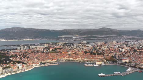 boat-marina-bay-on-Croatian-coastline,-aerial-establishing-drone-view