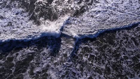Drone-bird's-eye-push-in-over-incoming-waves-at-Mavericks-Beach,-California