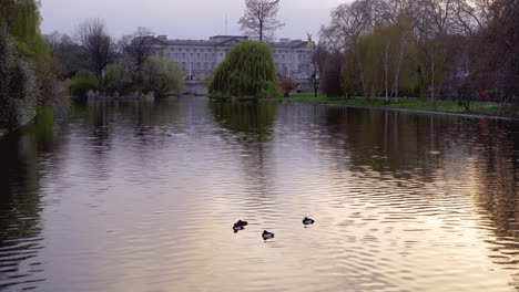 Buckingham-Palace-from-St-James's-Park-lake-with-flag-at-half-mast-for-death-of-Prince-Philip,-Duke-of-Edinburgh,-Saturday-April-10th,-2021---London-UK