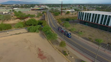 Drone-shot-following-the-Sun-Link-streetcar-on-a-road-in-Tucson-Arizona
