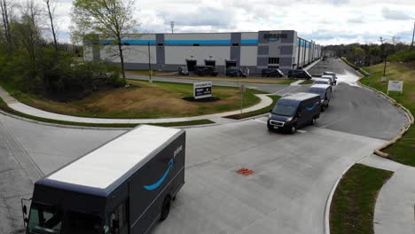 Amazon-delivery-vans-and-trucks-pull-out-of-an-Amazon-warehouse-on-the-Eastside-of-Columbus,-Ohio