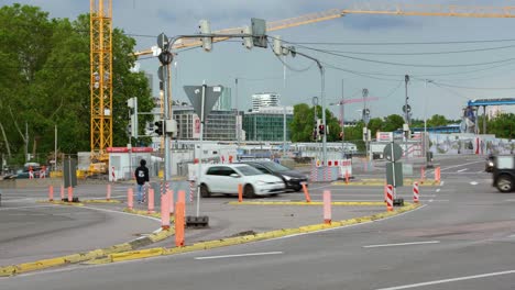 Busy-intersection-with-cars-and-people-obstructed-by-construction-site