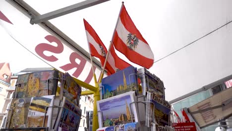 Postcards-and-flags-at-souvenir-store-in-Vienna,-Austria