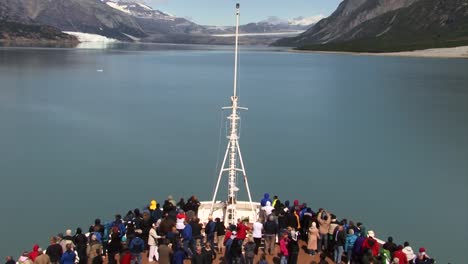 Tourists-on-the-bow-of-a-cruise-ship-in-Glacier-Bay-National-Park-Alaska,-enjoying-the-landscape
