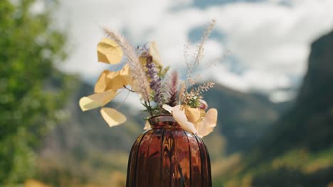 SLOW-MOTION-Flower-display-flowing-in-the-wind-with-mountains-in-the-background