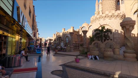 People-shopping-on-Old-market-street-near-Al-Sahaba-Mosque,-Sharm-El-Sheikh