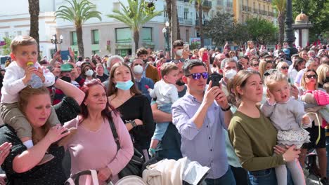 Worshippers-gather-outdoors-to-watch-the-Holy-Week-processions-in-Cadiz,-Spain