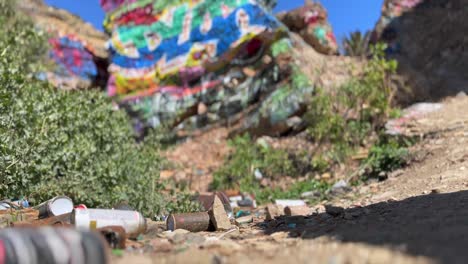 Empty-rusting-graffiti-aerosol-cans-garbage-left-at-Sunken-city-ruins-San-Pedro-California