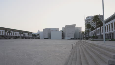 Zoom-in,-the-new-Great-Theater-of-Casablanca,-empty-Mohammed-V-square-at-sunrise