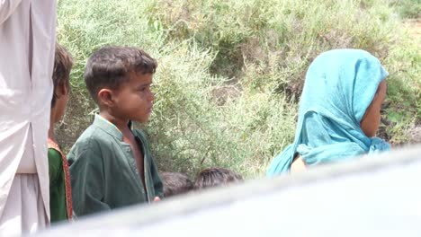 Children-standing-in-the-line-to-receive-the-aid-in-flood-relief-camp-in-Sindh,-Pakistan